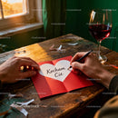 Writing a Heartfelt Valentine Message at Rustic Wooden Table