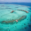 Overwater Bungalows in Turquoise Lagoon on Tropical Island