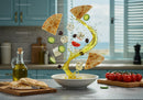 Mediterranean salad ingredients suspended with olive oil splash