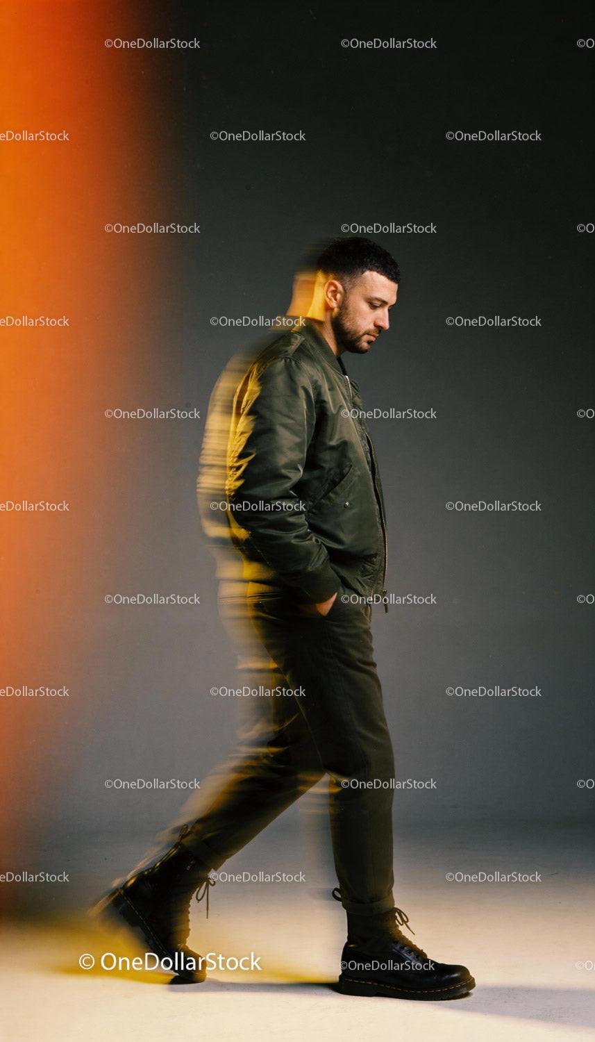 Man walking thoughtfully in dark casual outfit