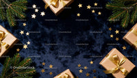 Christmas gifts with golden stars and fir branches on dark