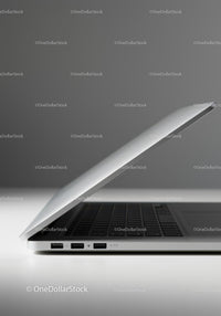 Silver Laptop on White Surface with Gray Background