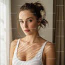 Elegant Young Woman with Blue Eyes and Flowered Hair in Sunlit Room