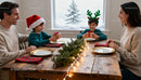 Family exchanging gifts during cozy Christmas dinner