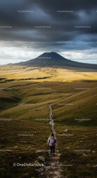 Mountain Hiking Trail with Dark Clouds Over Rolling Green Hills