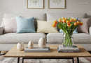 Cozy living room with pastel pillows and tulip bouquet