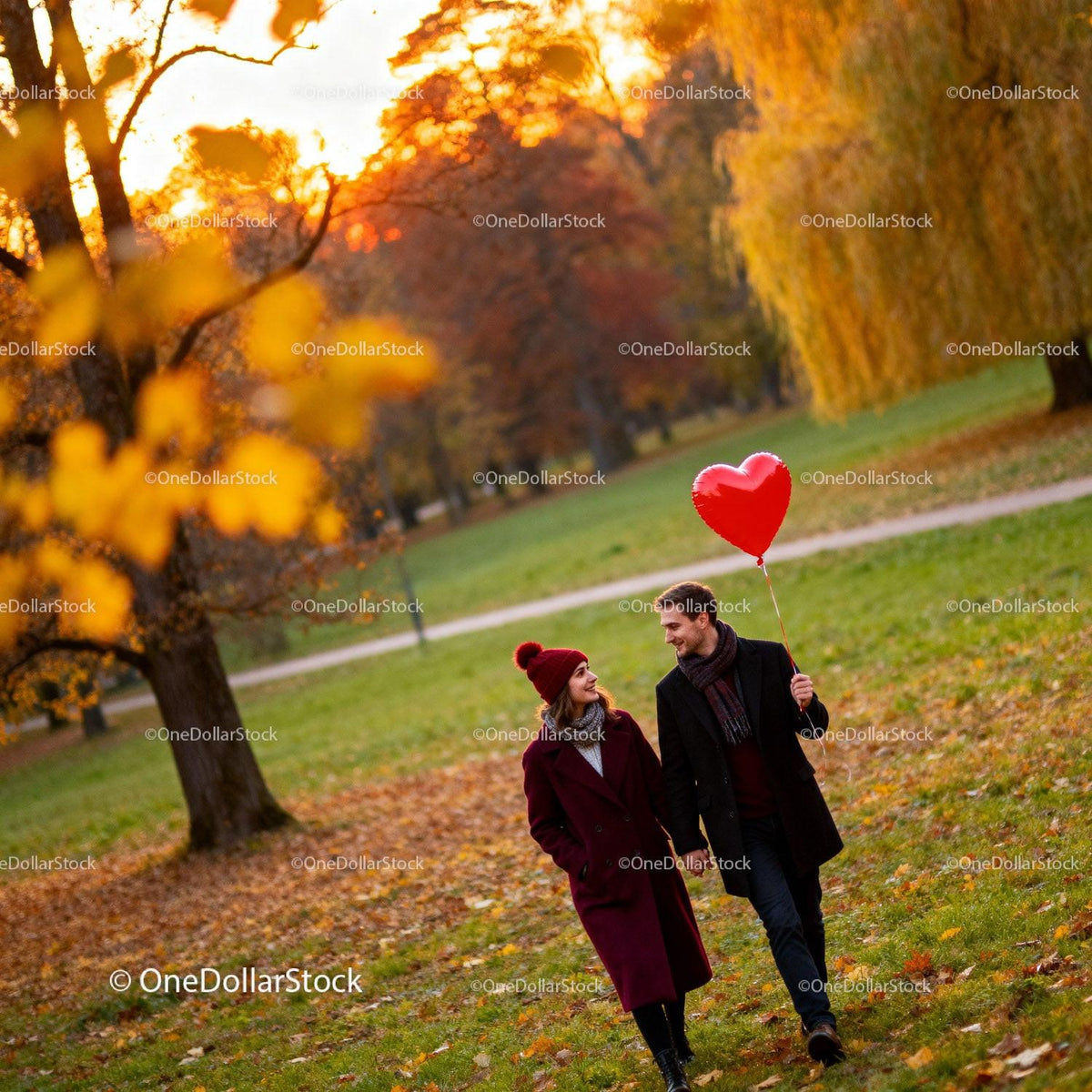 Couple enjoying autumn walk with heart-shaped balloon