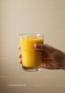 Hand Holding Glass of Fresh Mango Smoothie