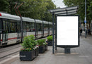 Urban tram stop with blank advertising billboard outdoors