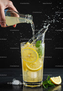 Refreshing Lemon Drink Being Poured with Splash Effect