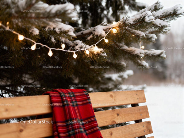 Snowy pine tree with festive lights and cozy plaid scarf