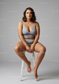 Confident Plus Size Woman Relaxing in Casual Sportswear on Studio Seat