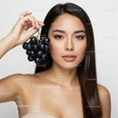 Elegant Woman with Black Grapes for Skincare and Wellness Concept