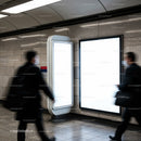 Blurred commuters passing bright empty billboards