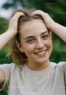 Young Woman Smiling Outdoors With Freckles and Natural Beauty