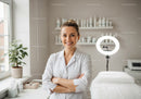 Professional Female Healthcare Worker in White Coat in Modern Clinic