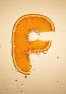 Fresh orange slice shaped like letter F with water drops
