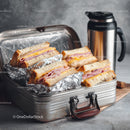 Stack of Ham and Cheese Sandwiches in a Metal Lunch Box