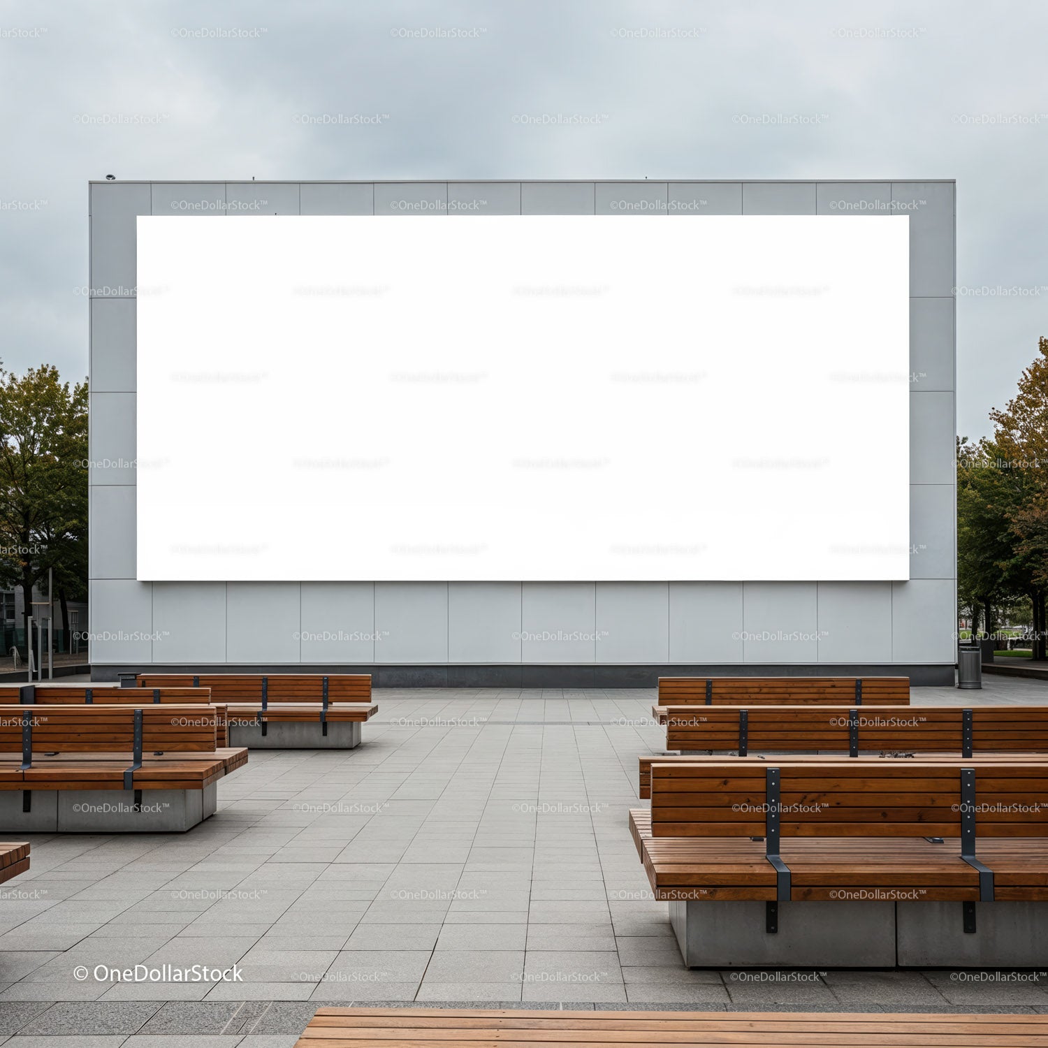 Empty outdoor seating area with large blank billboard