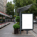 Modern tram stop with blank advertisement board in city