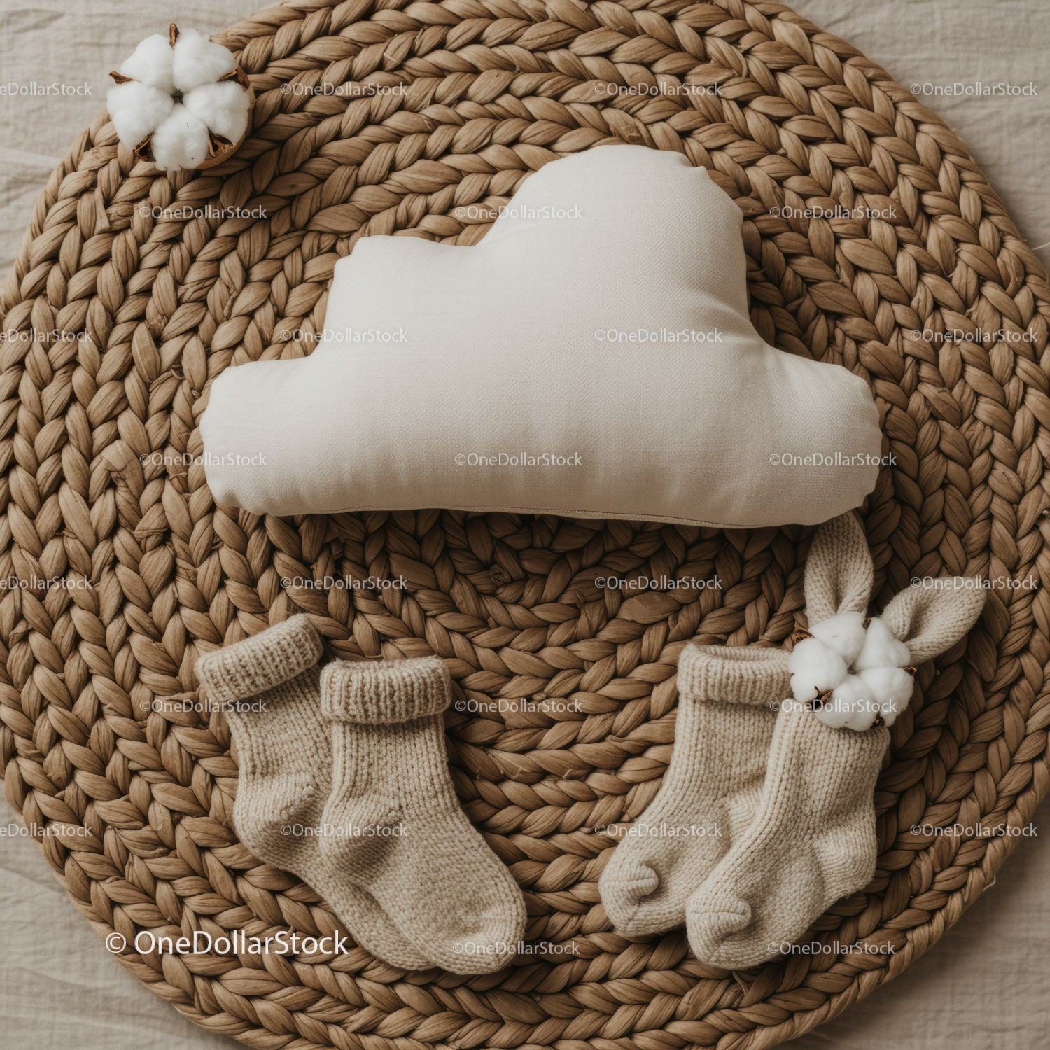 Cozy baby socks and cloud pillow on woven mat