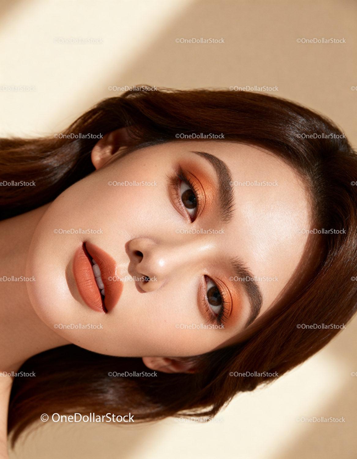 Close-up of woman with warm toned makeup and brown hair