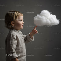 Toddler Reaching Out to Fluffy White Cloud