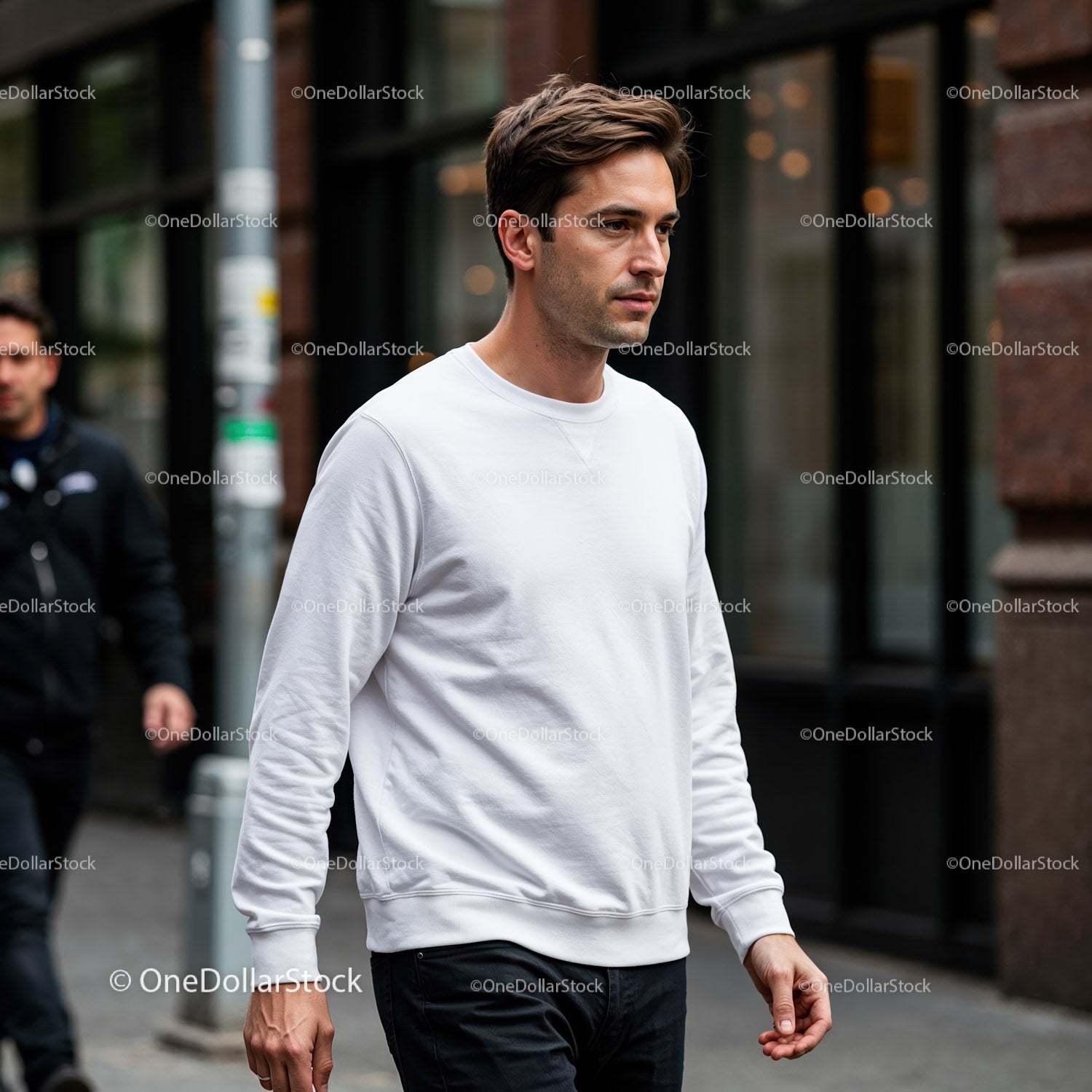 Man in White Sweatshirt Walking Calmly on City Street