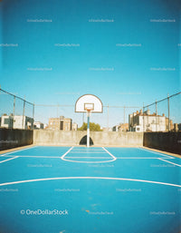 Urban Rooftop Basketball Court with Bright Blue Surface and Hoop