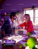 Couple Playfully Baking Heart Cookies Together at Home