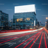 Evening traffic streaks past modern city building