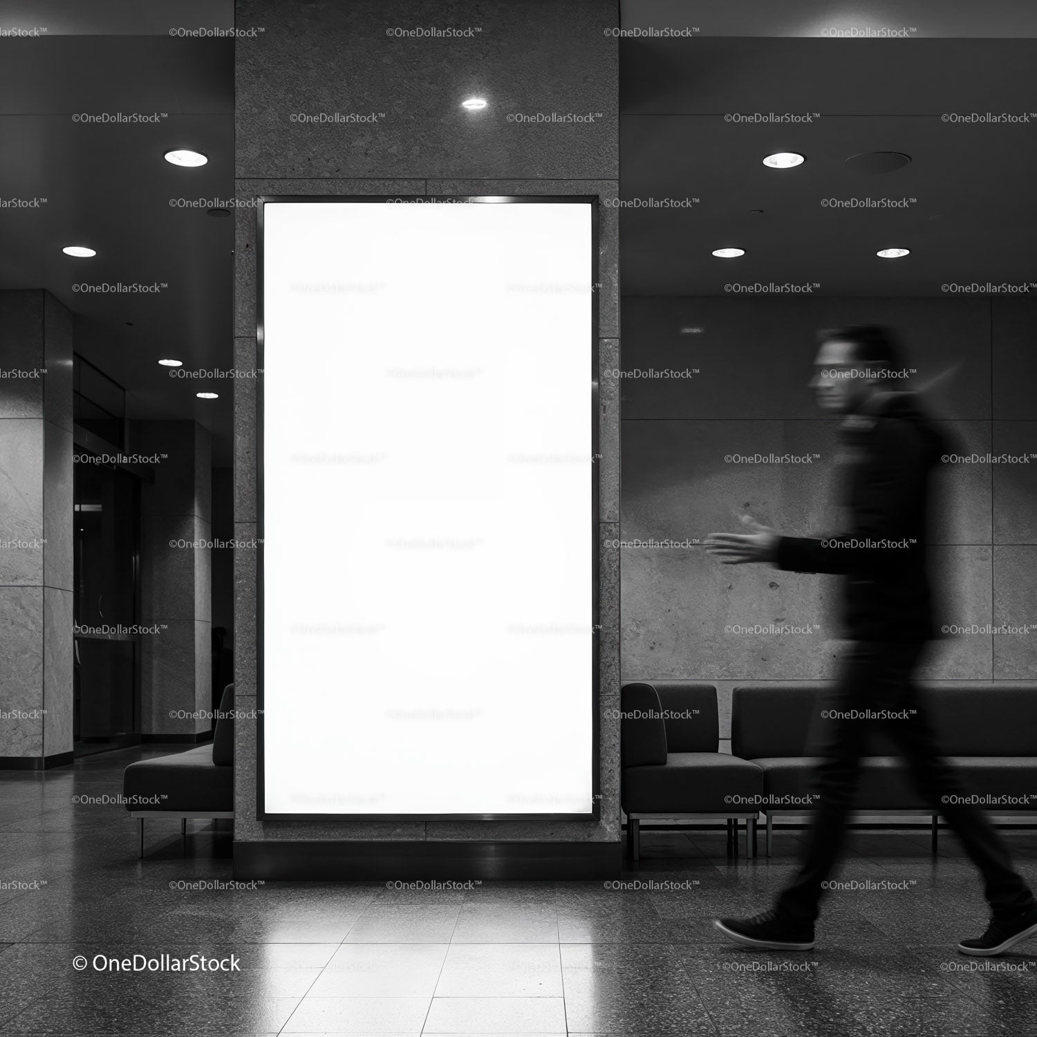 Blurred man walking by empty billboard in modern lobby