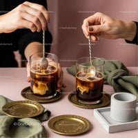 Stylish Iced Coffee with Gold Accents and Cozy Pink Background