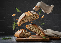 Rustic sourdough bread slices floating with herbs