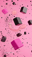 Black Sugar Cubes with Pink Liquid Drops on Vibrant Pink Background