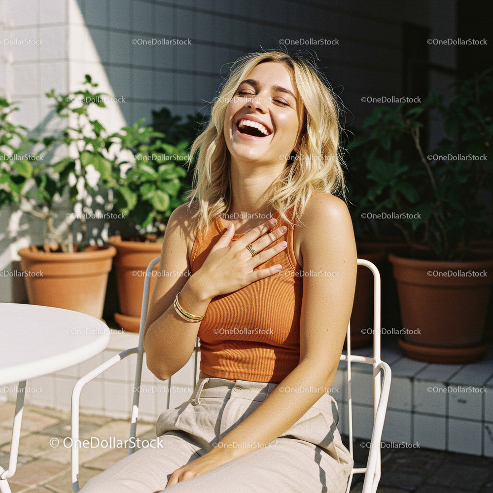 Joyful Woman Laughing in a Bright Outdoor Setting