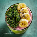 Banana Slices and Kale in Vibrant Pink Smoothie with Fruit Garnishes