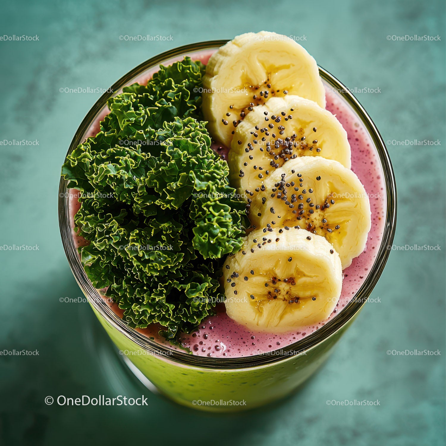 Banana Slices and Kale in Vibrant Pink Smoothie with Fruit Garnishes