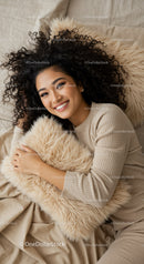 Smiling woman relaxing with cozy fluffy pillow at home