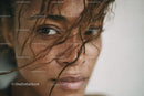 Close-up of Young Woman with Wet Curly Hair and Intense Gaze