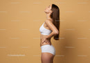Slim Female Model in White Sportswear Posing Against Minimalist Background