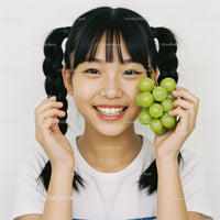 Happy Young Woman Holding Green Grapes with Bright Smile