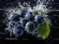 Fresh Blueberries with Water Splash and Green Leaf in Dark Background