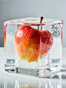 Red apple frozen inside a transparent ice cube