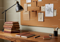 Cozy wooden desk with books and creative corkboard notes