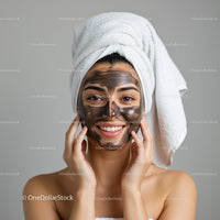 Young Woman Applying Facial Mud Mask for Skin Rejuvenation and Relaxation