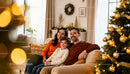 Happy family relaxing together near decorated Christmas tree