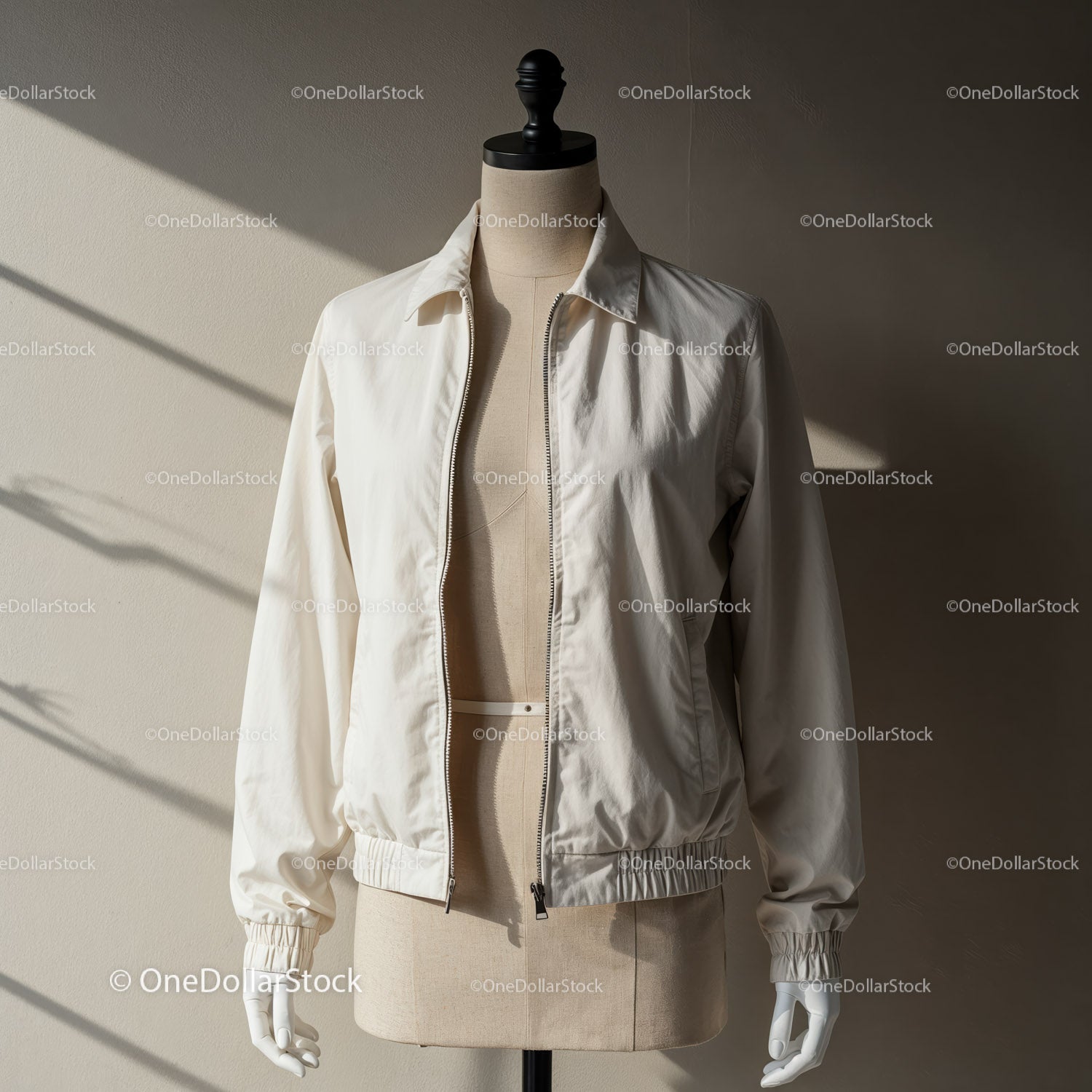 Minimalist cream jacket displayed on tailor mannequin