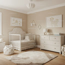 Decorative Nursery with White Baby Crib and Cute Wall Art