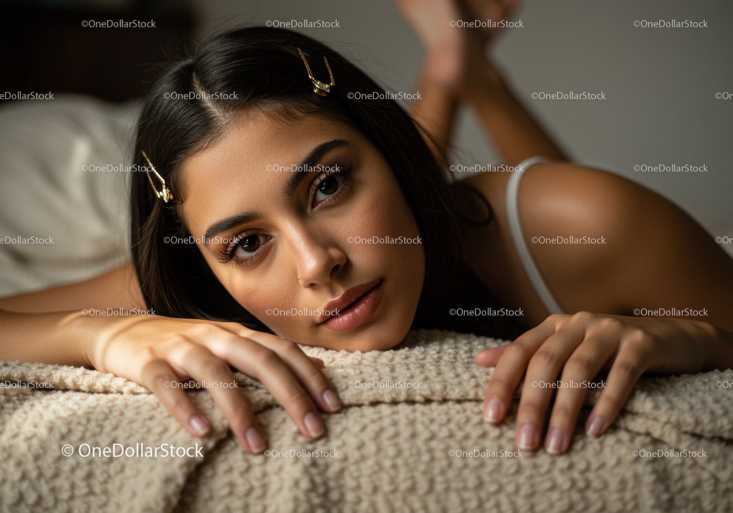 Young Woman Relaxing on Carpet with Beautiful Brown Eyes and Gold Hair Clips